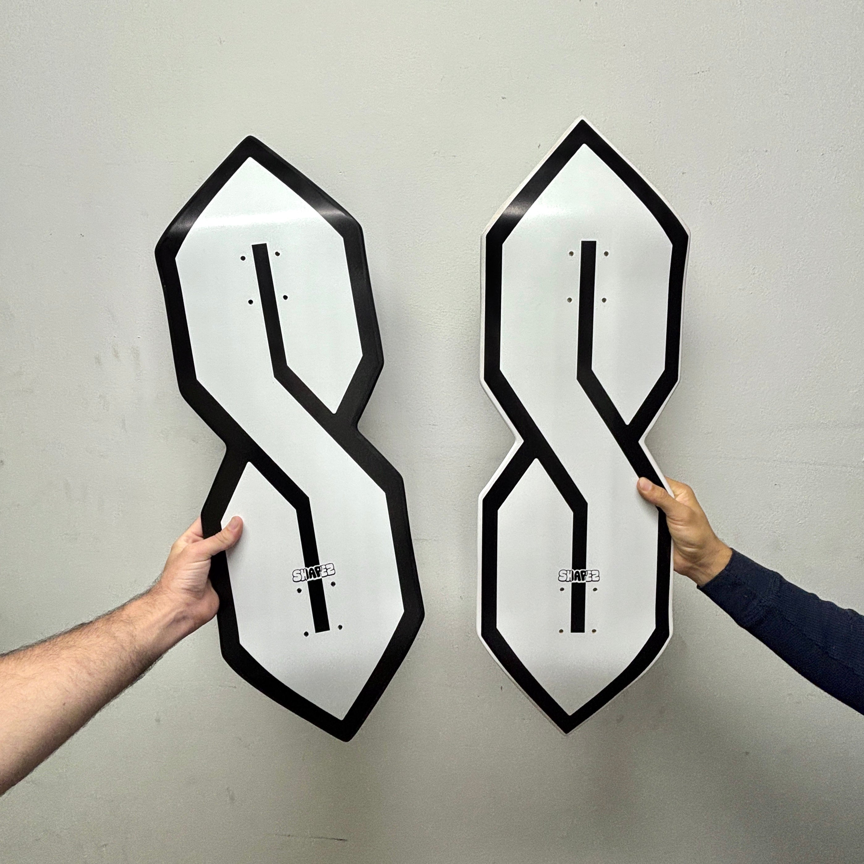 S shaped skateboard deck black outline white outline